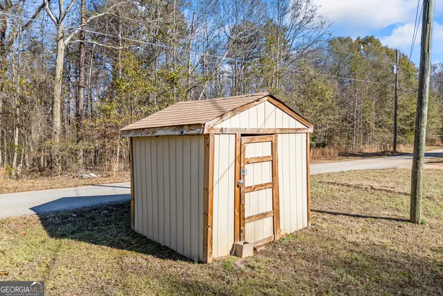 a view of backyard of house and car parked