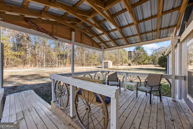a view of a porch with furniture and wooden floor