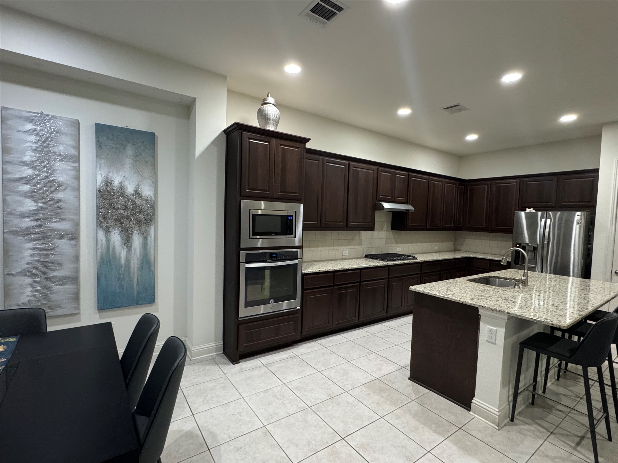 5821 Buchanan Draw Road Austin, TX 78738 - Photo 6 of 18 This kitchen showcases ample dark wood cabinetry and luminous granite countertops.
