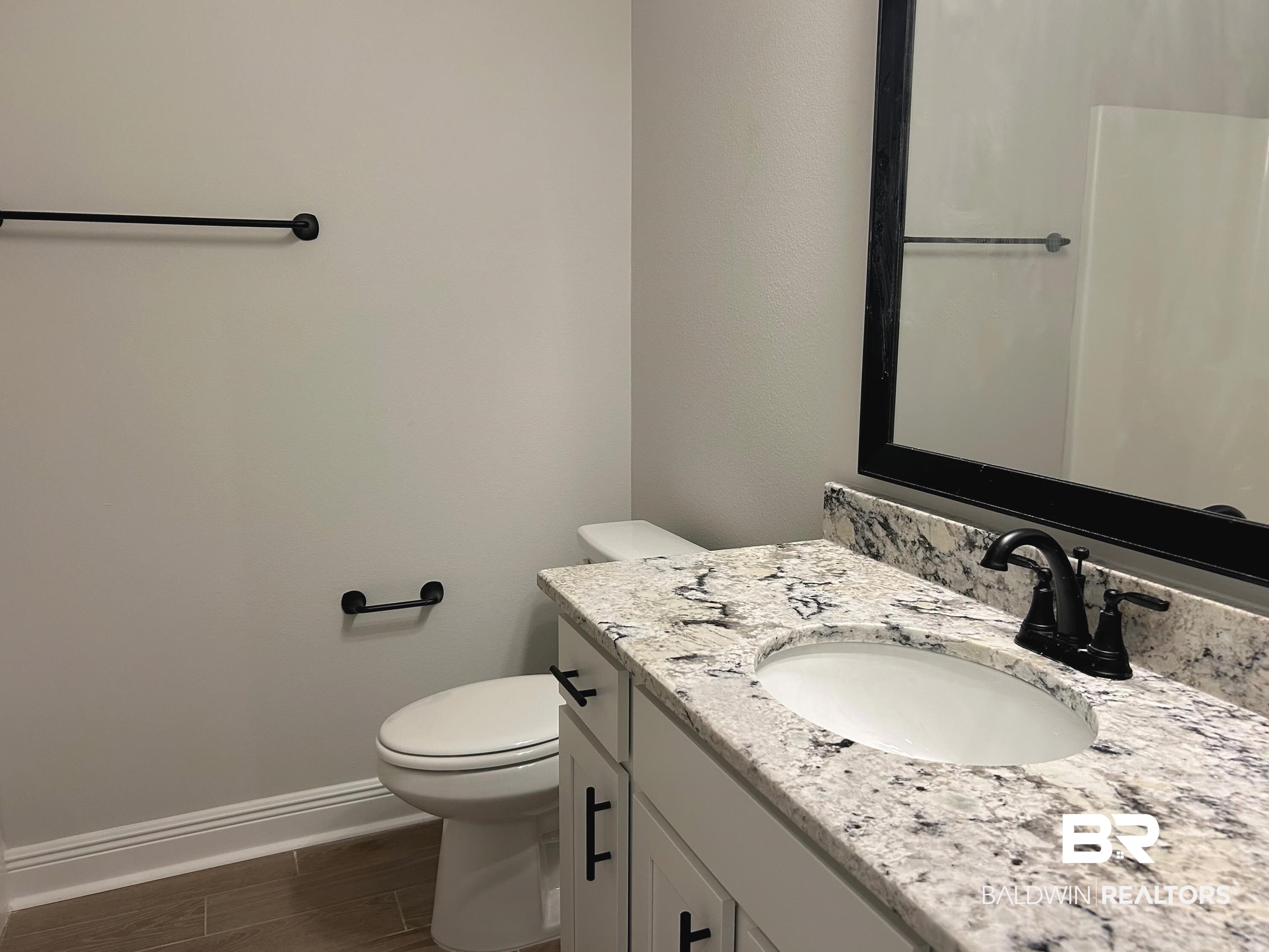 860 Sumter Loop Foley, AL 36535 - Photo 19 of 26 Bathroom featuring vanity, hardwood / wood-style floors, and toilet