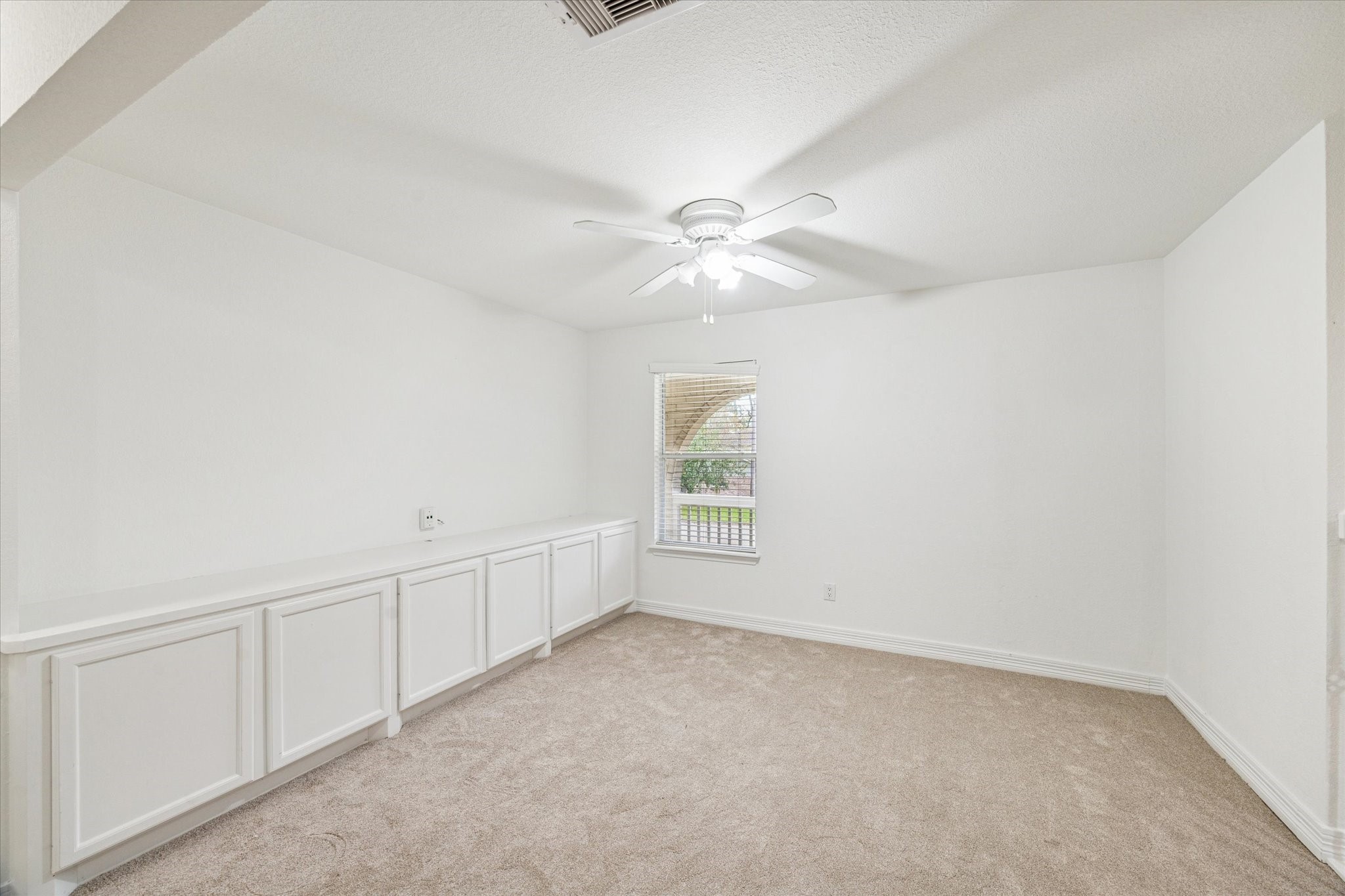 4314 Oxhill Road Spring, TX 77388 - Photo 14 of 22 Upstairs flex space with wall of built-ins and flush neutral carpeting would make a great study/home office, game room, workout area or other flex space.