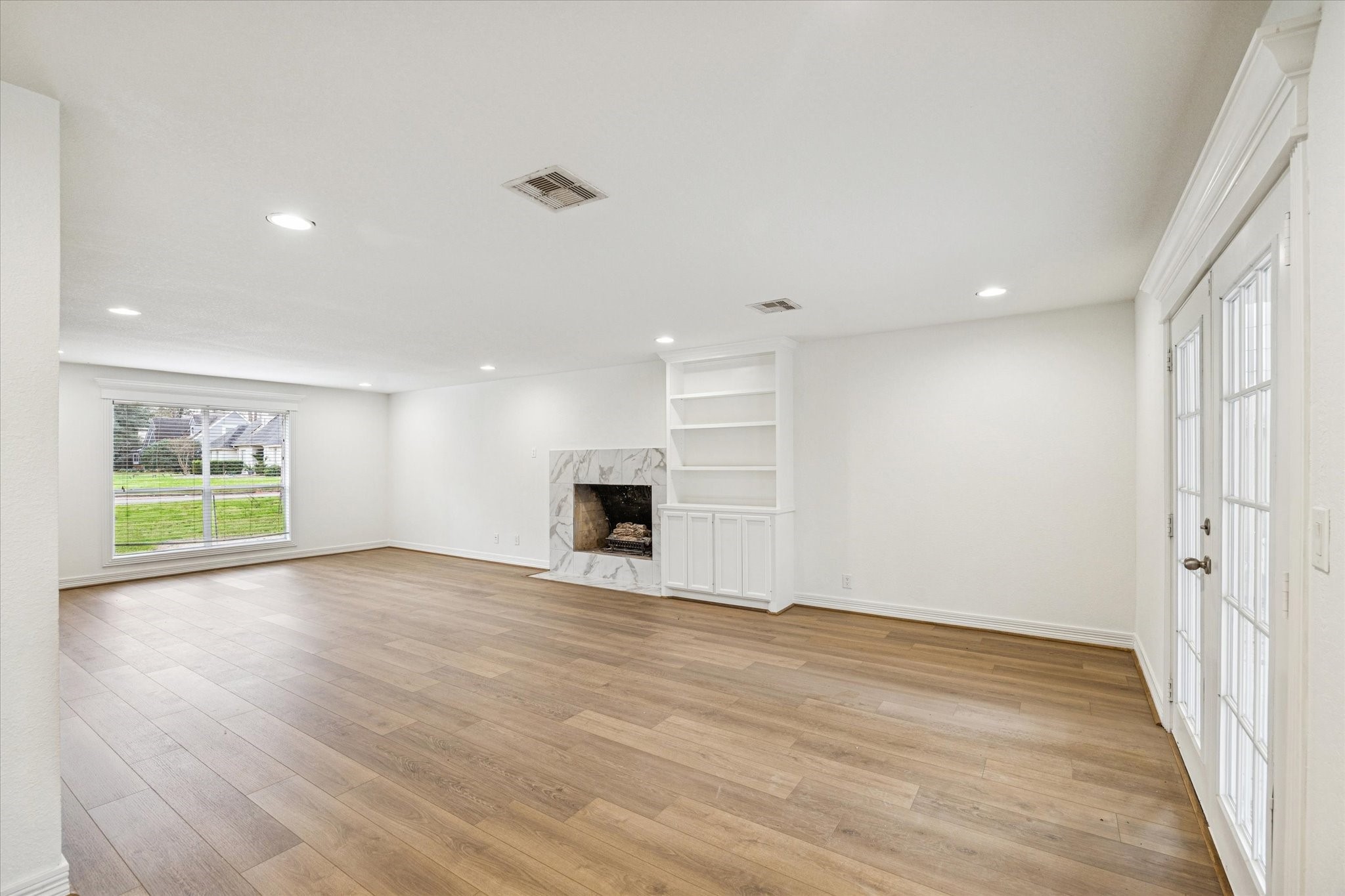 4314 Oxhill Road Spring, TX 77388 - Photo 6 of 22 Another view of den from kitchen with engineered wood floors and French on the right to the back patio.
