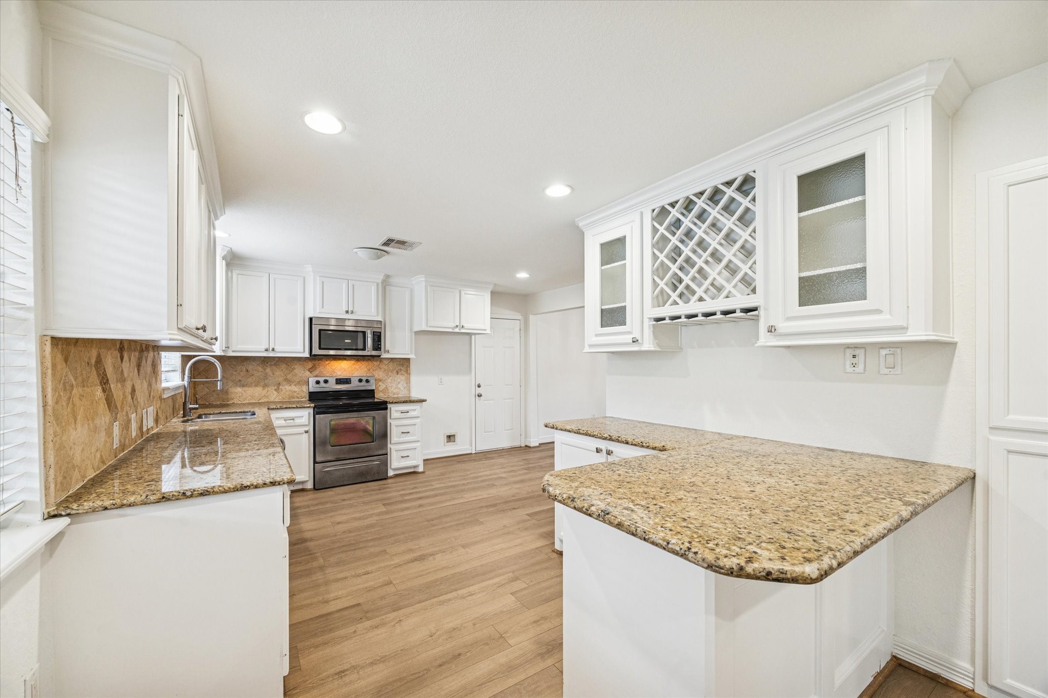 4314 Oxhill Road Spring, TX 77388 - Photo 7 of 22 Kitchen with granite countertops, wine rack and glass front cabinets.
