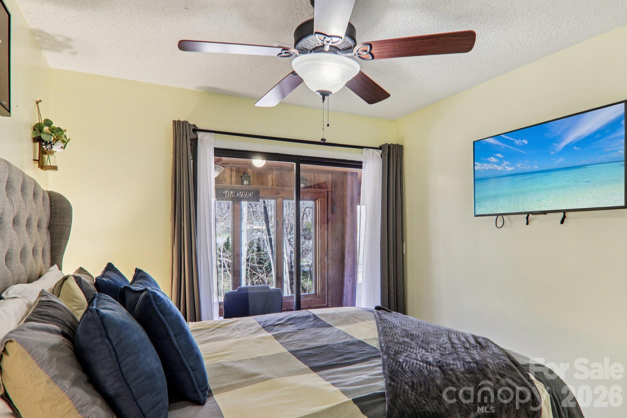 129 Riverside Villa Drive Maggie Valley, NC 28751 - Photo 22 of 43 a bedroom with a bed and a painting on the wall