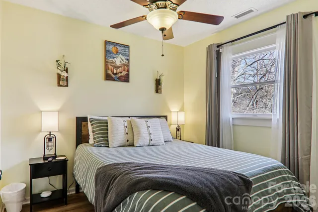 a bedroom with bed and a window