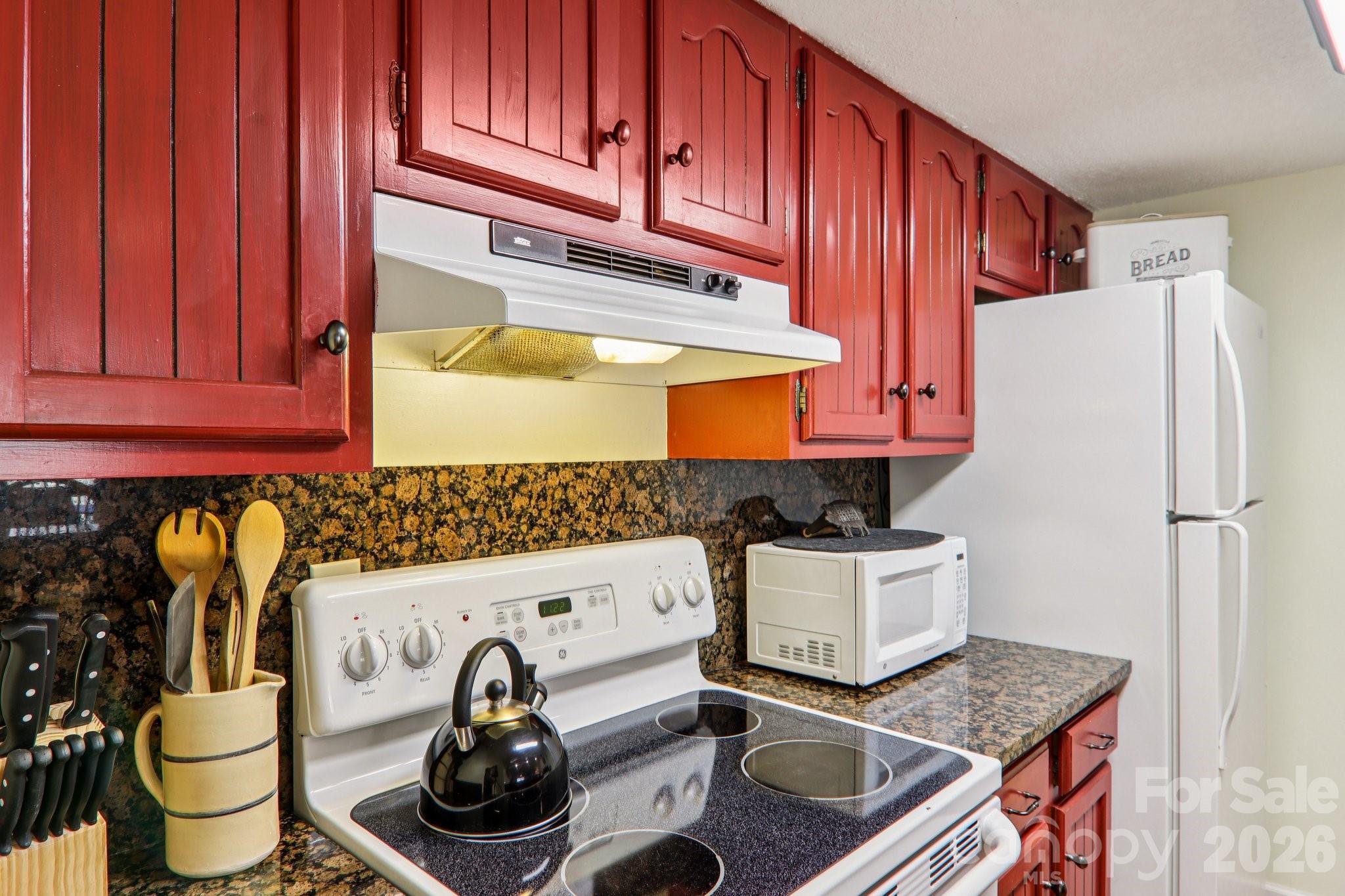 129 Riverside Villa Drive Maggie Valley, NC 28751 - Photo 31 of 43 a kitchen with stainless steel appliances granite countertop a sink and cabinets