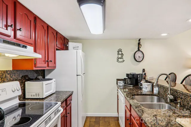 a dining room with furniture a fireplace and wooden floor