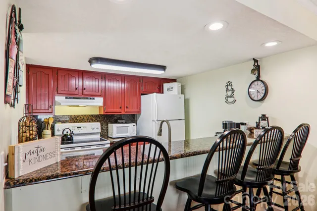 a view of a livingroom with furniture and a flat screen tv
