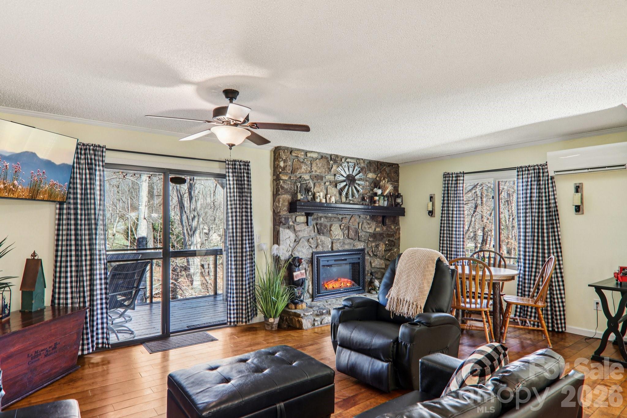 129 Riverside Villa Drive Maggie Valley, NC 28751 - Photo 38 of 43 a living room with furniture a flat screen tv and a fireplace