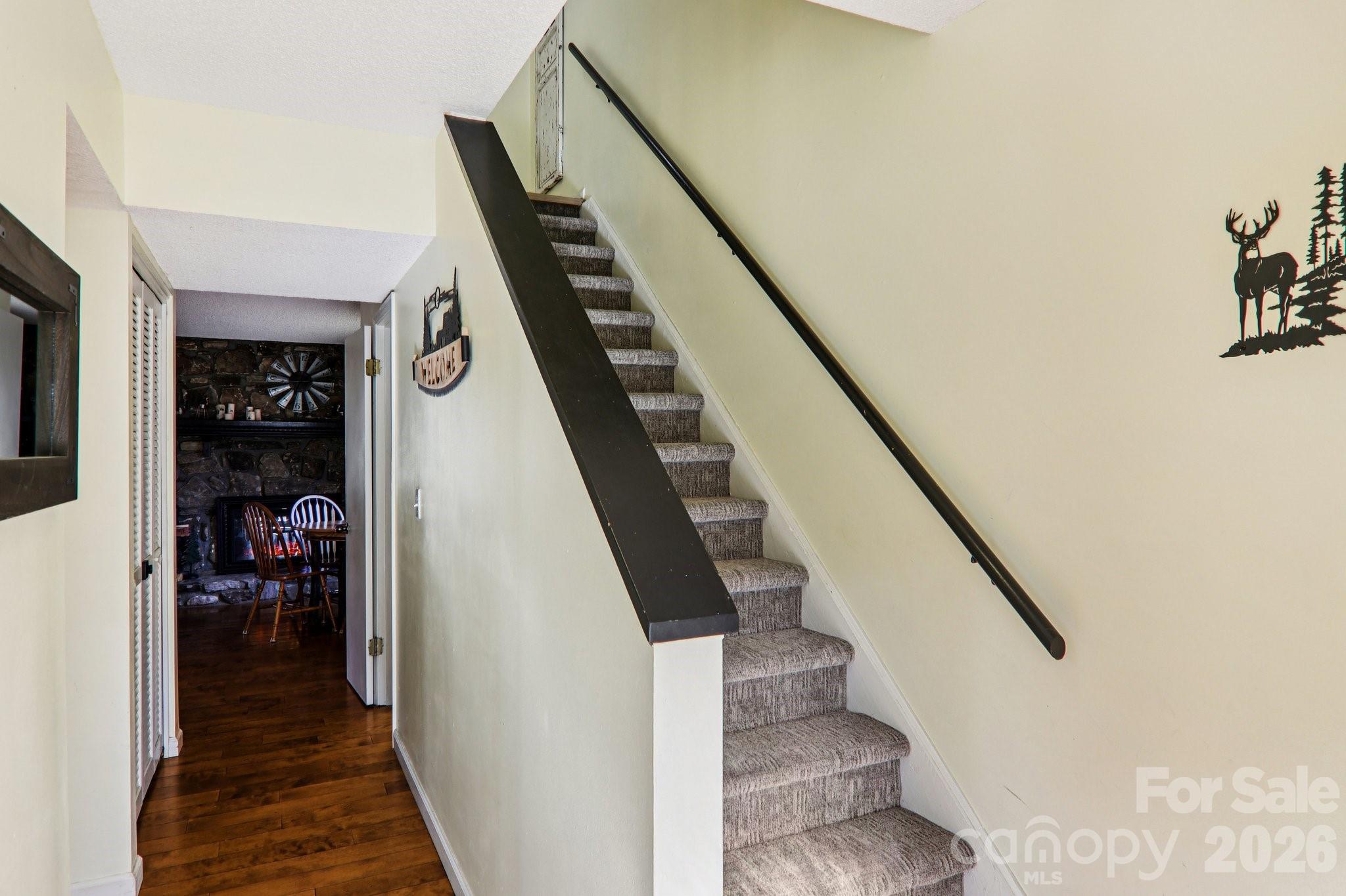 129 Riverside Villa Drive Maggie Valley, NC 28751 - Photo 10 of 43 a view of a hallway with wooden floor and staircase