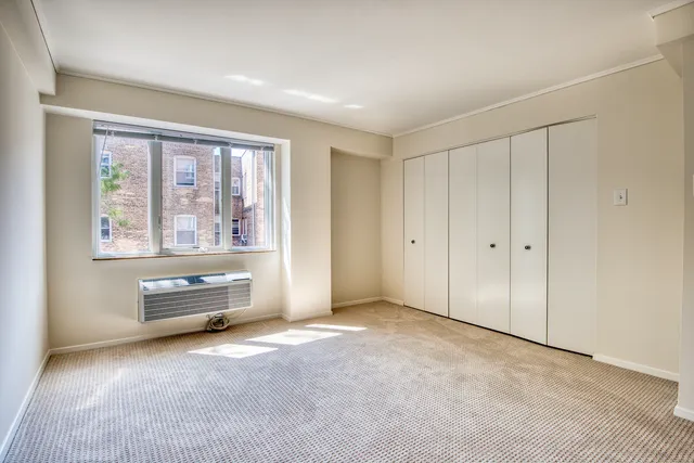 an empty room with furniture and windows