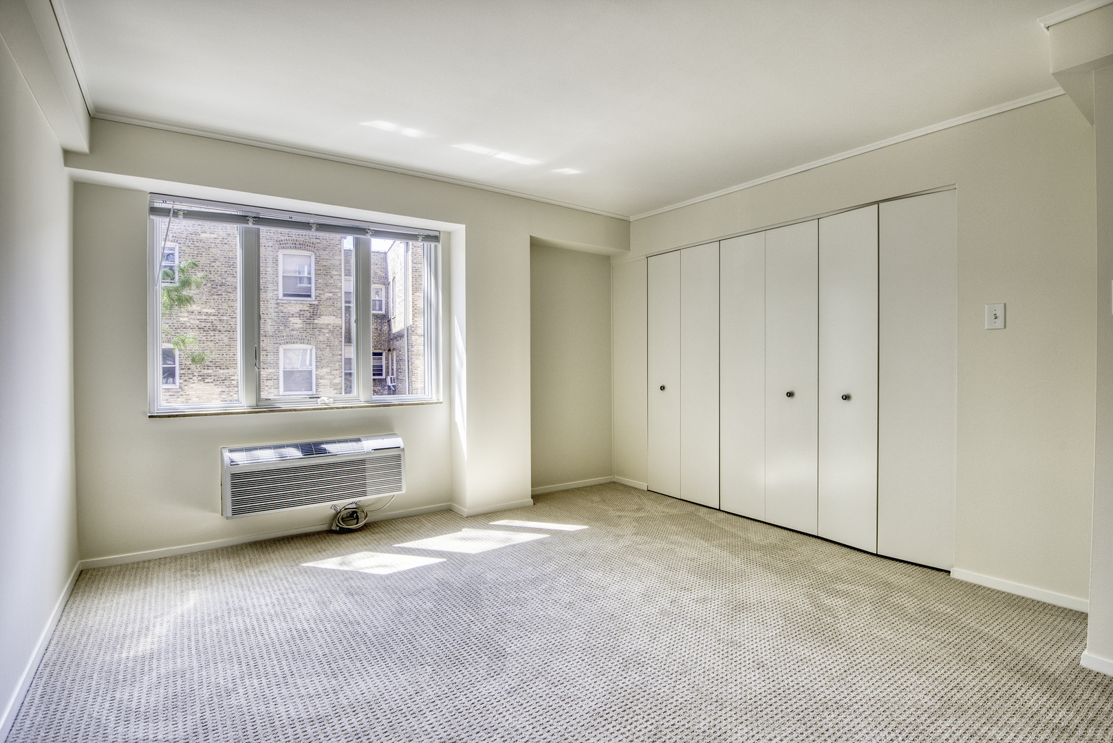 1020 Grove Street, Unit 301 Evanston, IL 60201 - Photo 14 of 23 an empty room with furniture and windows