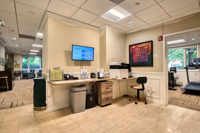 a kitchen with stainless steel appliances a stove sink refrigerator dining table and chairs