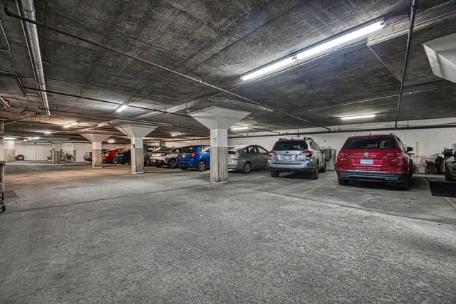 a view of parking garage with cars