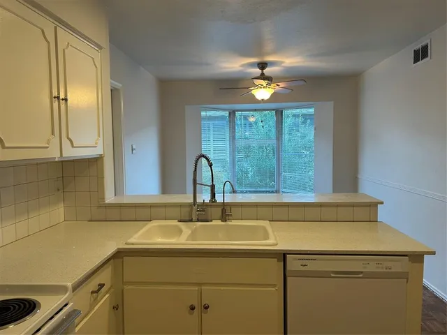 a yellow house in middle of the forest