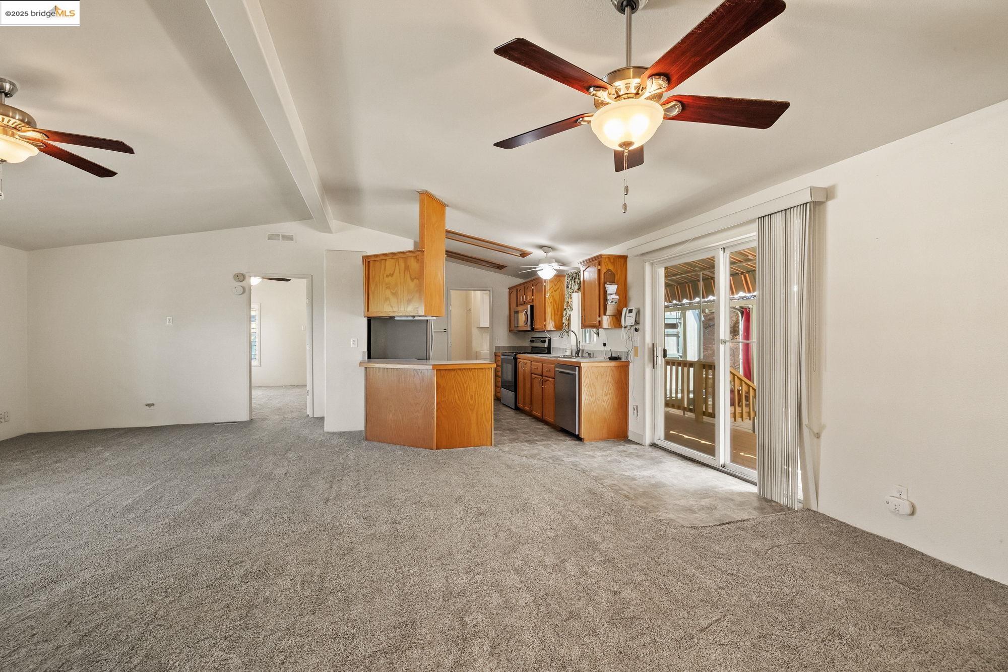 23732 Parrotts Ferry Road, Unit SPC 47 Columbia, CA 95310 - Photo 14 of 31 a view of a livingroom with a ceiling fan a kitchen view and a window