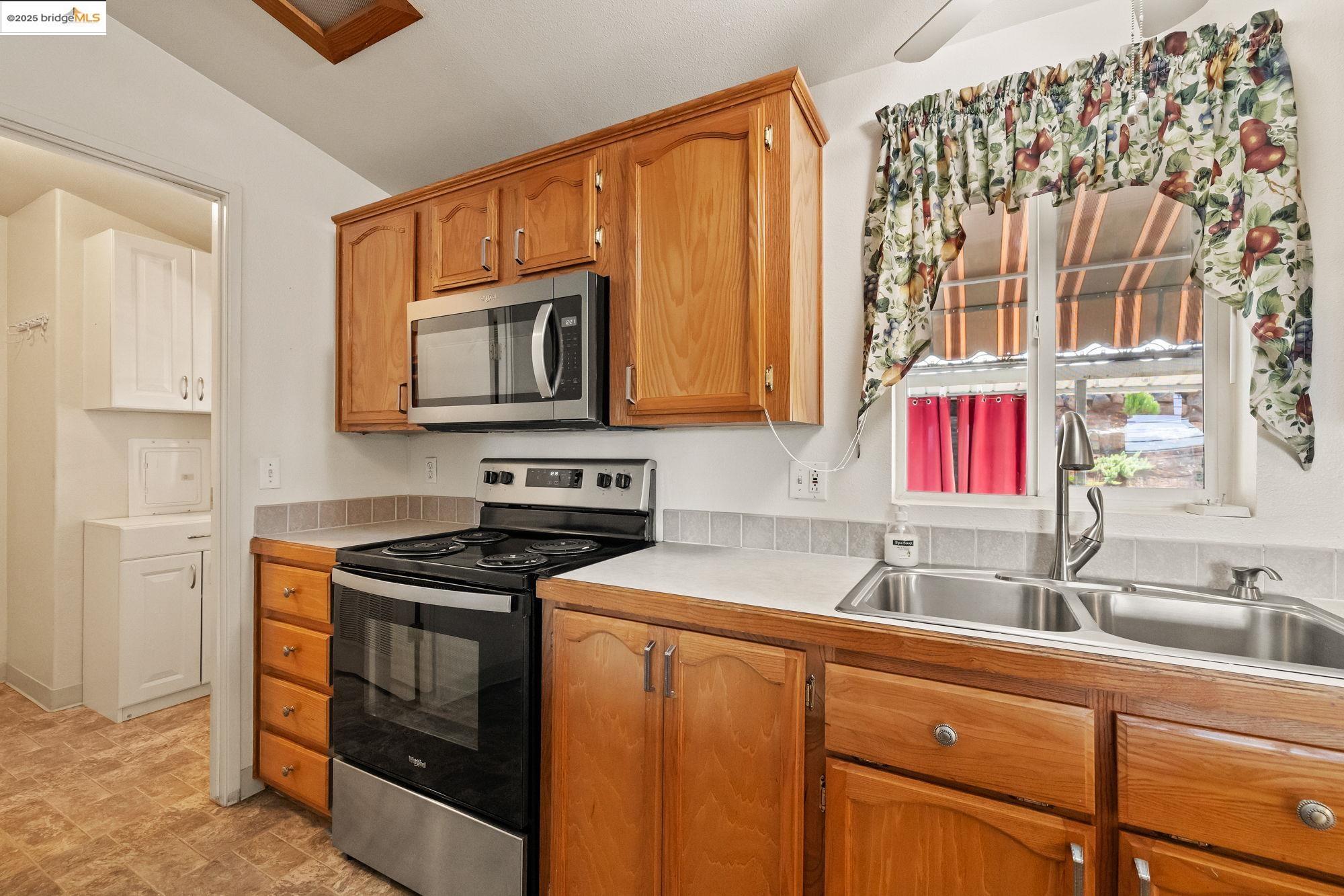 23732 Parrotts Ferry Road, Unit SPC 47 Columbia, CA 95310 - Photo 16 of 31 a kitchen with stainless steel appliances granite countertop a sink stove and cabinets