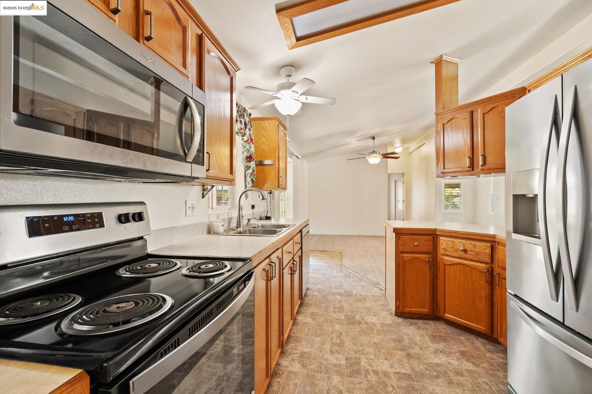 23732 Parrotts Ferry Road, Unit SPC 47 Columbia, CA 95310 - Photo 17 of 31 a kitchen with stainless steel appliances granite countertop a stove and a refrigerator