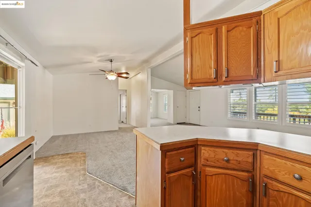 a kitchen with granite countertop cabinets and window
