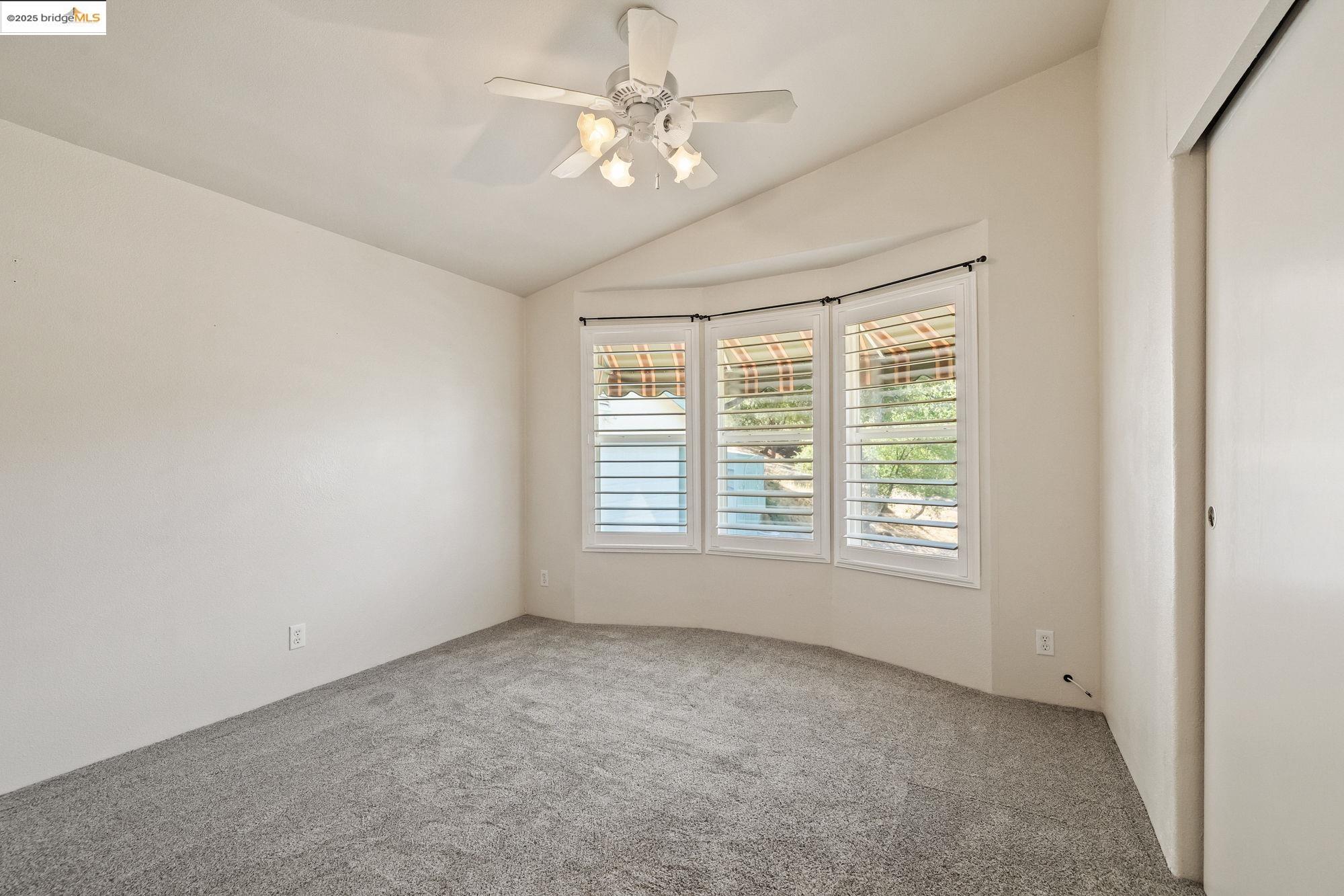 23732 Parrotts Ferry Road, Unit SPC 47 Columbia, CA 95310 - Photo 23 of 31 an empty room with a window and a ceiling fan