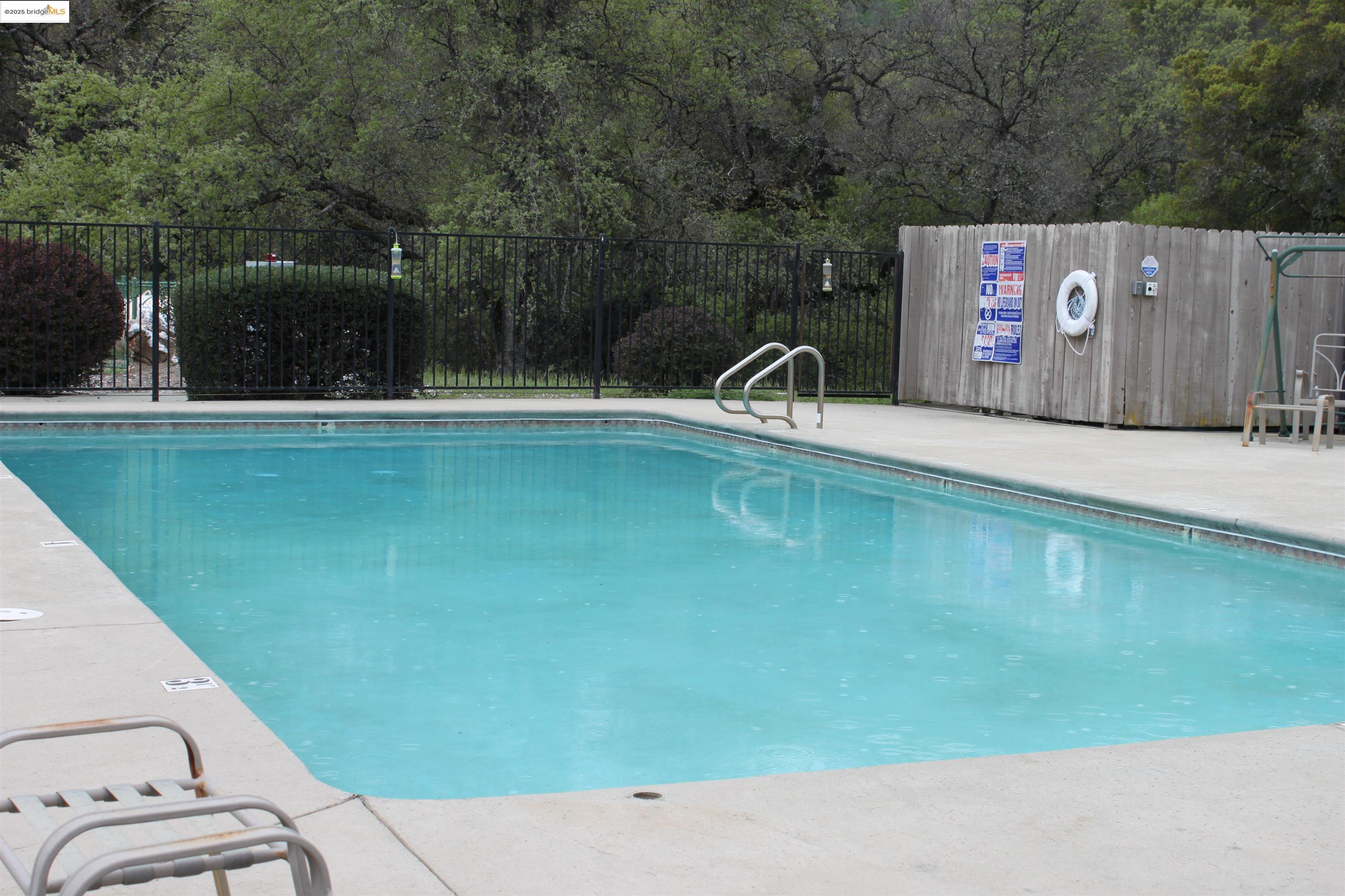 23732 Parrotts Ferry Road, Unit SPC 47 Columbia, CA 95310 - Photo 31 of 31 a view of a swimming pool with a bench in the background