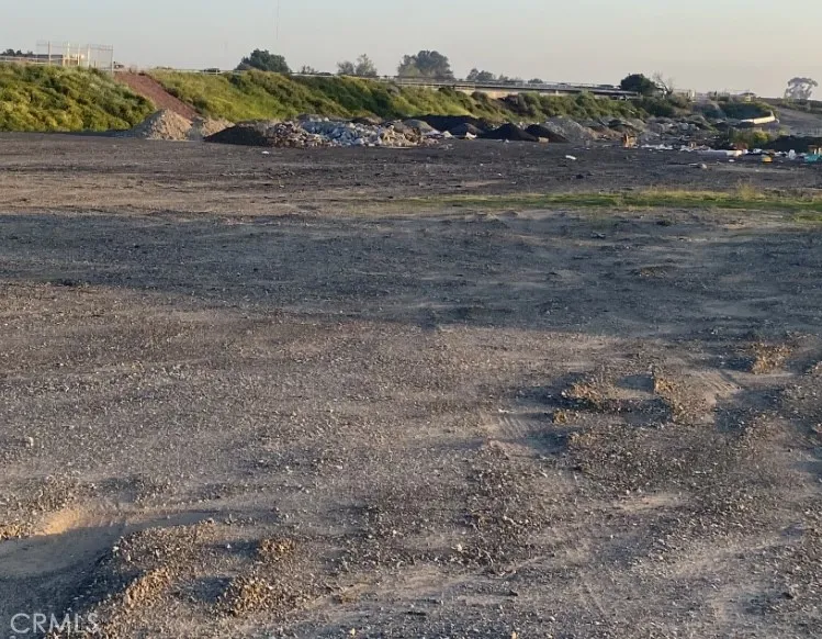 3 Rosecrans Avenue Paramount, CA 90723 - Photo 1 of 2 a view of a dry yard with wooden fence