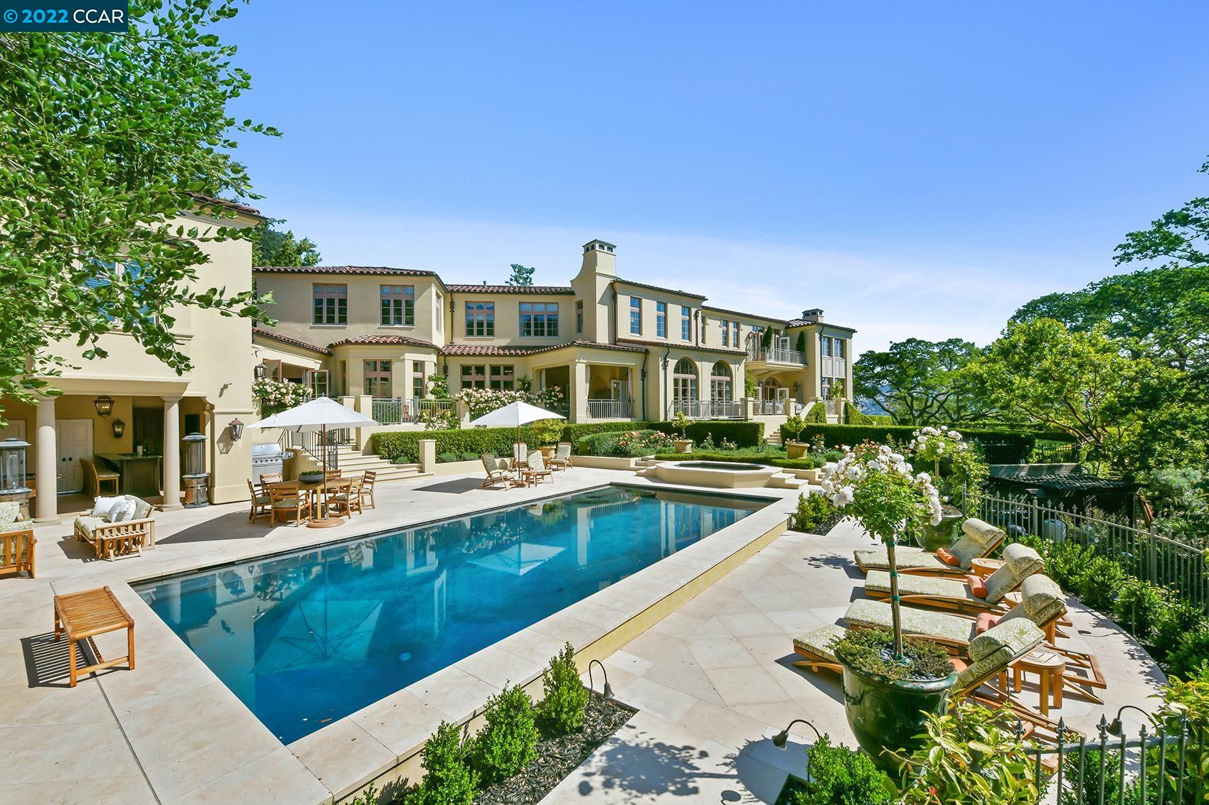 a swimming pool with outdoor seating and yard