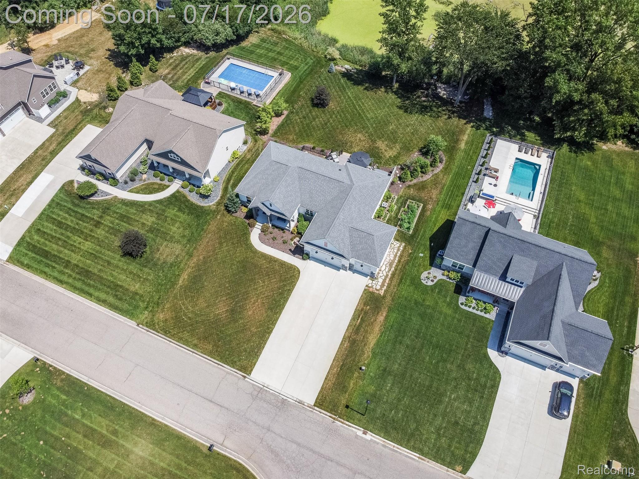 12349 Sugar Maple Drive Fenton, MI 48430 - Photo 67 of 67 Modern-style home featuring a dark gray roofline, a concrete driveway, and a manicured lawn