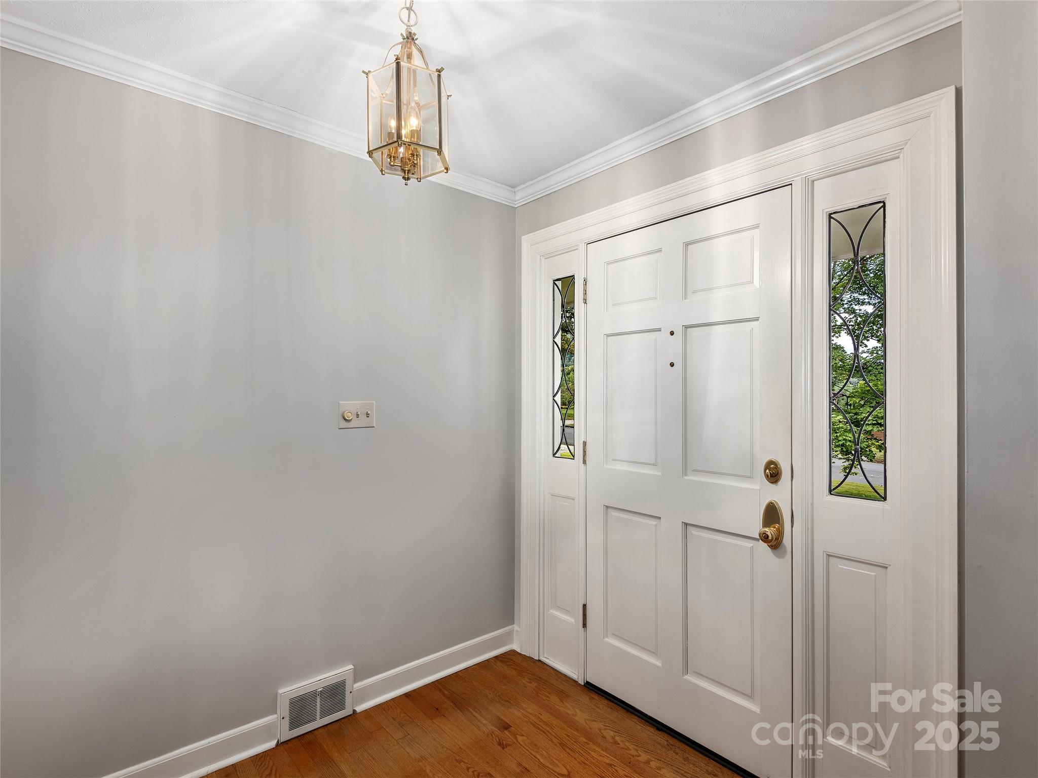 7 East Fox Chase Road Asheville, NC 28804 - Photo 4 of 30 a view of a room with wooden floor and white walls