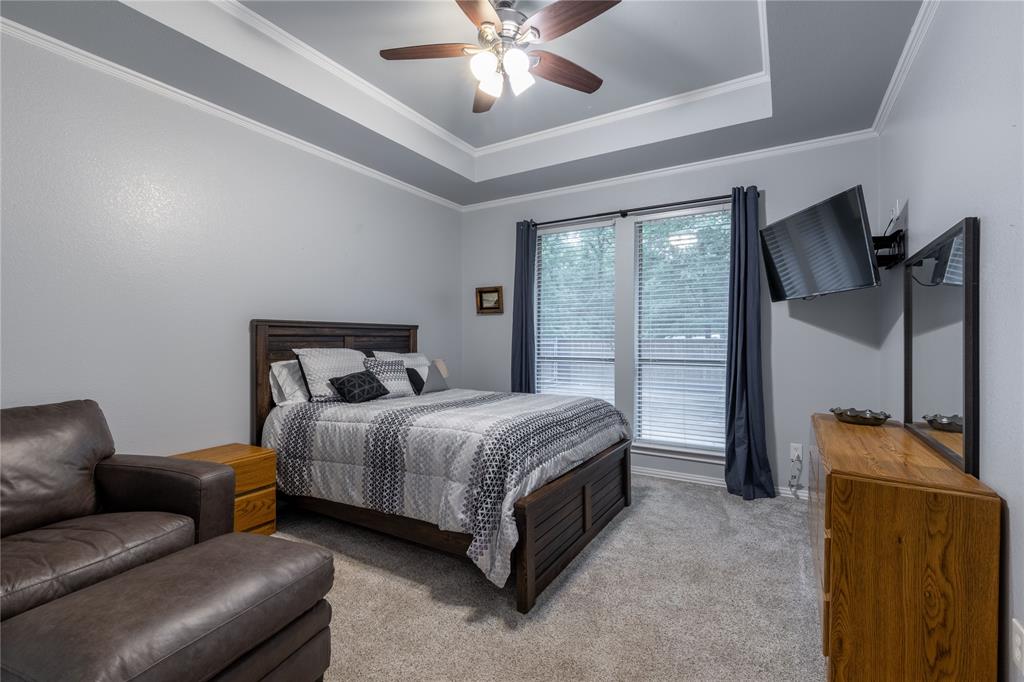 320 Rustic Oaks Road Combine, TX 75159 - Photo 29 of 40 Carpeted bedroom featuring a raised ceiling, ceiling fan, and crown molding