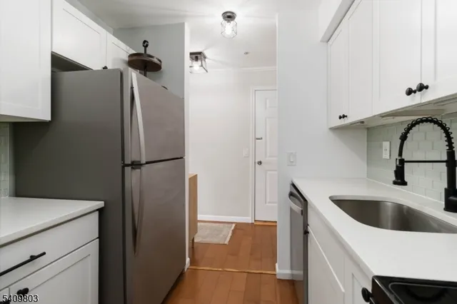 a kitchen with a refrigerator and a sink