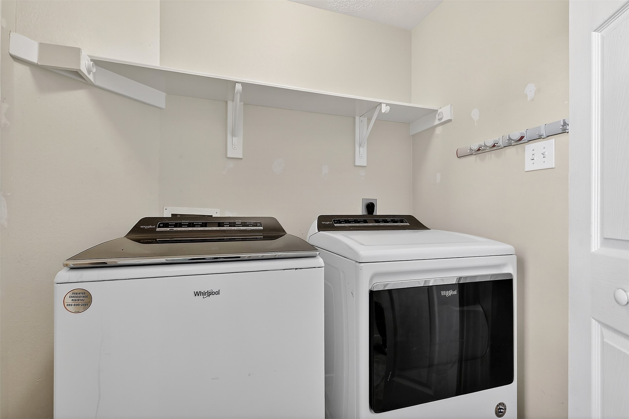 9319 Hudson Bend Circle Houston, TX 77095 - Photo 11 of 42 Laundry room situated across the half bathroom in the back of the kitchen towards the back exit to the backyard