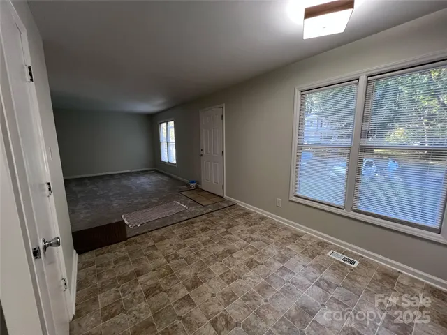 a view of a room with a wooden floor and a window