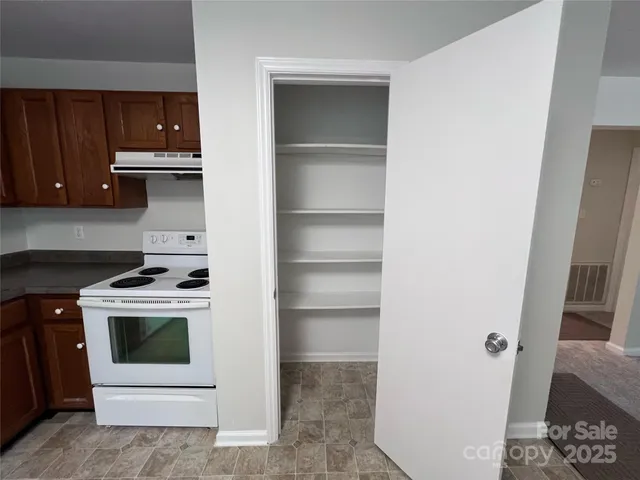 a kitchen with a stove and a refrigerator