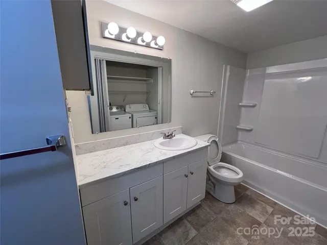 a bathroom with a toilet a sink and bathtub
