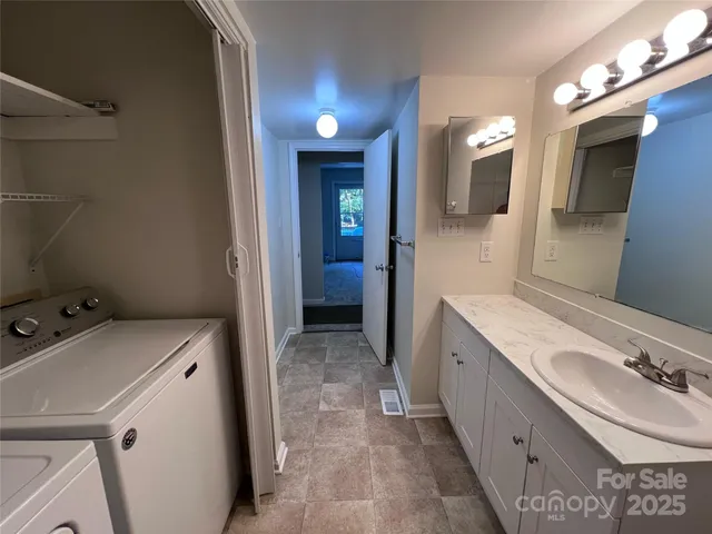a bathroom with a sink a toilet and mirror