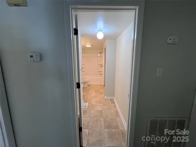 a view of a bathroom from a hallway