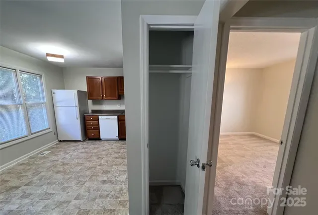 a view of kitchen with refrigerator cabinet and microwave