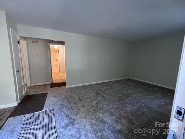 a view of an empty room and wooden floor