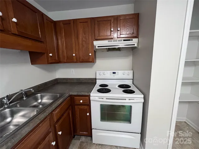 a kitchen with a stove and a sink