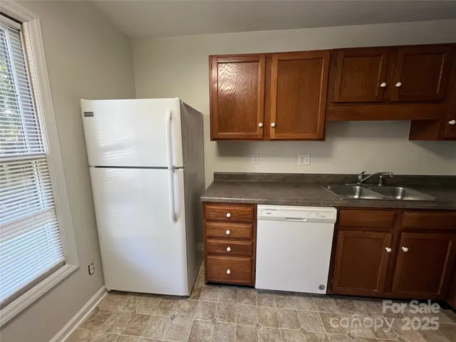 a kitchen with a refrigerator sink and cabinets