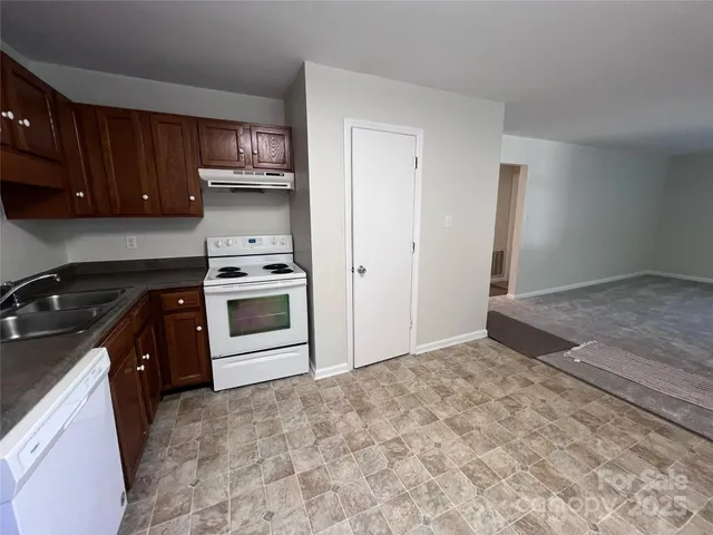 a kitchen with a stove sink and a refrigerator