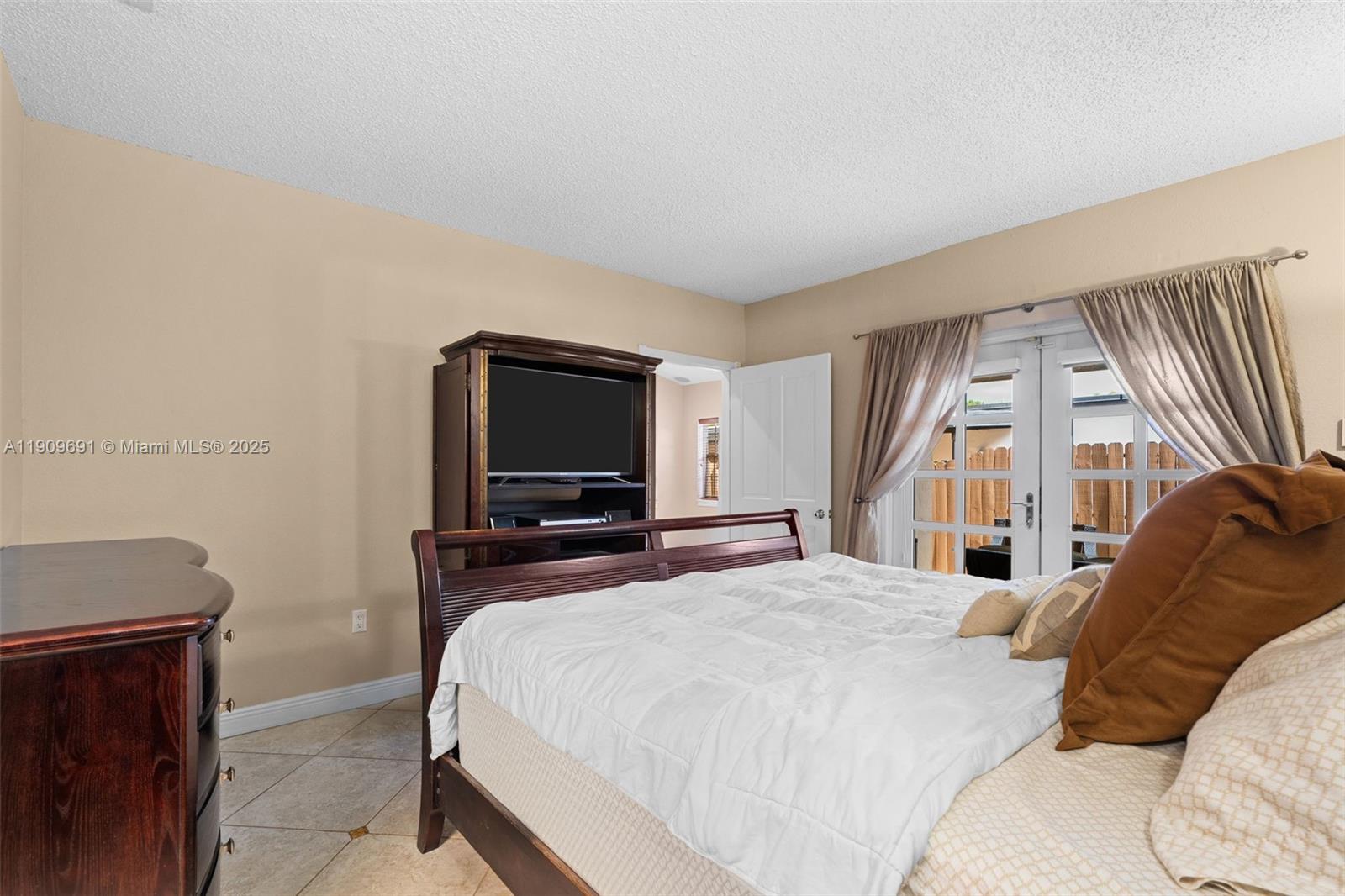 3510 Southwest 13th Street Miami, FL 33145 - Photo 13 of 30 a bedroom with a bed and a flat screen tv