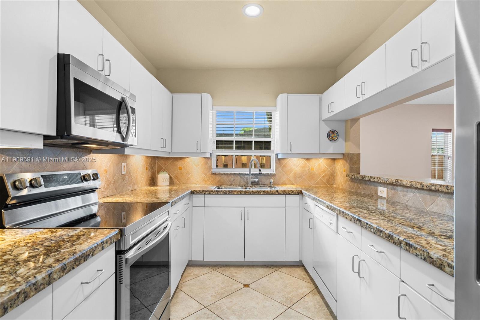3510 Southwest 13th Street Miami, FL 33145 - Photo 7 of 30 a kitchen with granite countertop a sink stainless steel appliances and cabinets