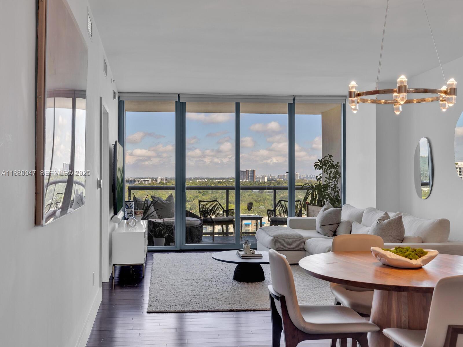 601 Northeast 36th Street, Unit 1304 Miami, FL 33137 - Photo 13 of 40 a living room with furniture and a floor to ceiling window