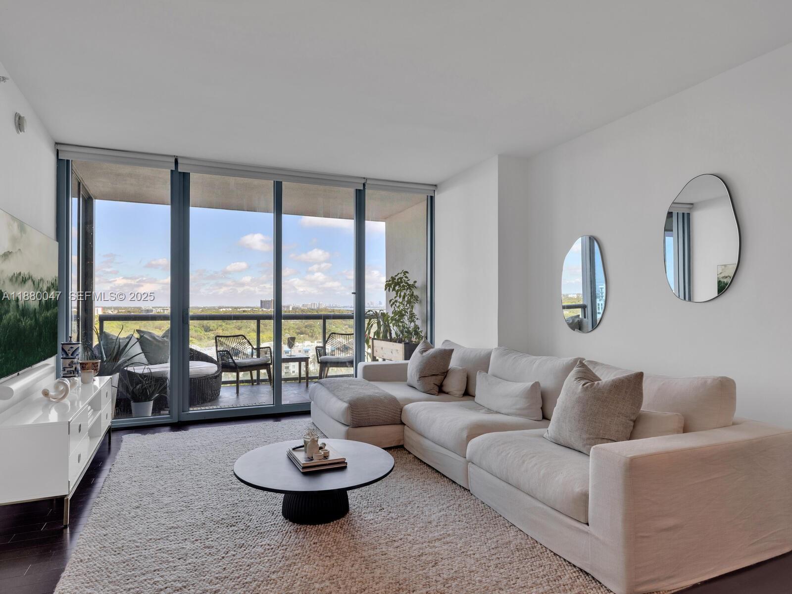 601 Northeast 36th Street, Unit 1304 Miami, FL 33137 - Photo 15 of 40 a living room with furniture and a large window