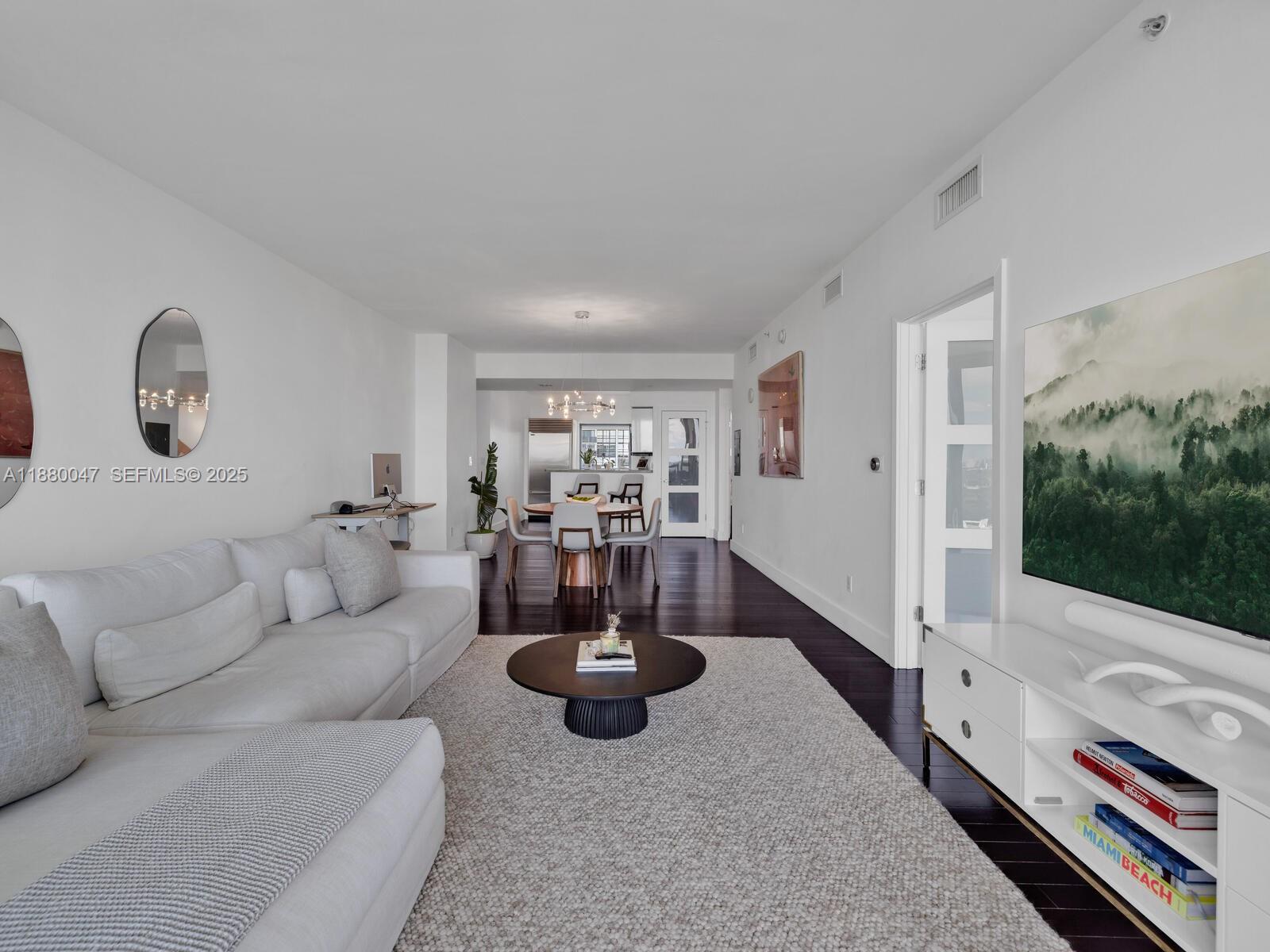 601 Northeast 36th Street, Unit 1304 Miami, FL 33137 - Photo 17 of 40 a living room with furniture and a flat screen tv