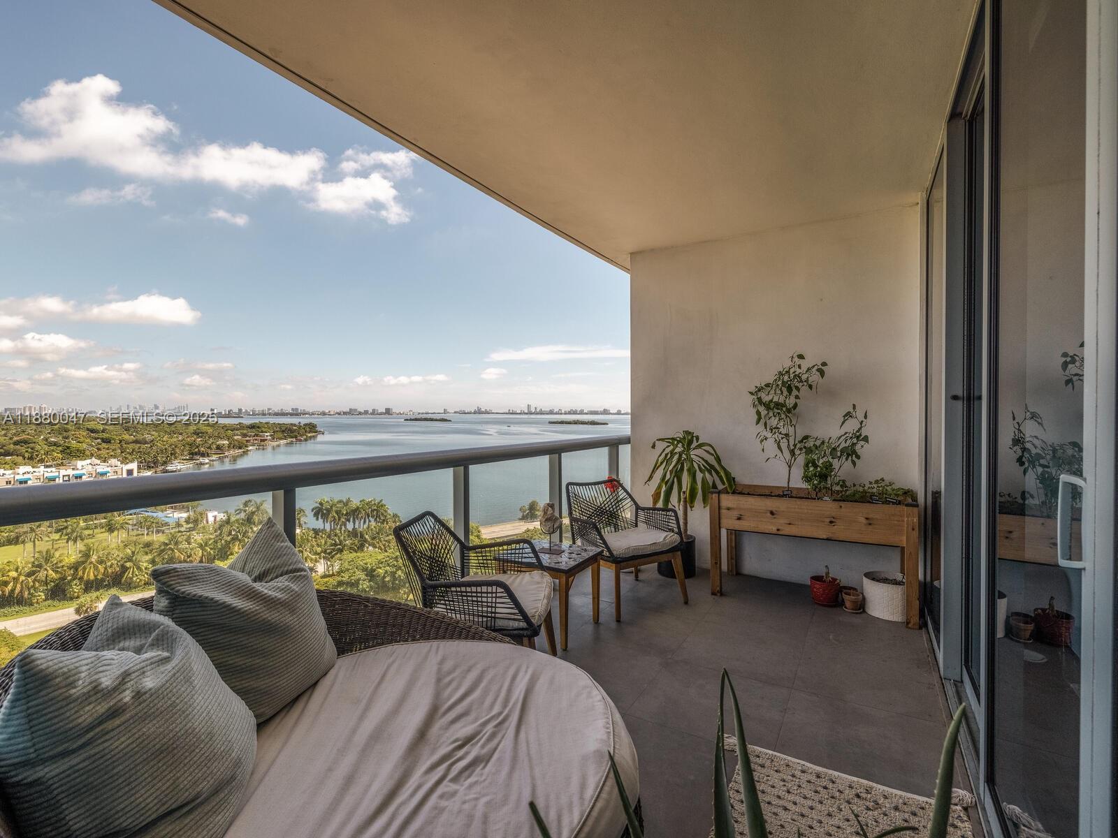 601 Northeast 36th Street, Unit 1304 Miami, FL 33137 - Photo 19 of 40 a balcony with furniture and city view