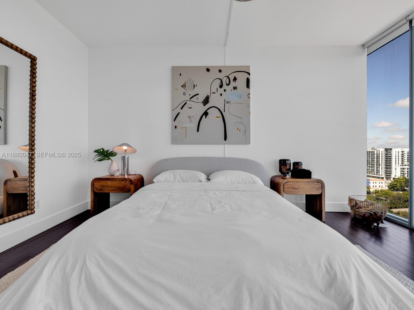 601 Northeast 36th Street, Unit 1304 Miami, FL 33137 - Photo 25 of 40 a bedroom with a bed and a painting on the wall