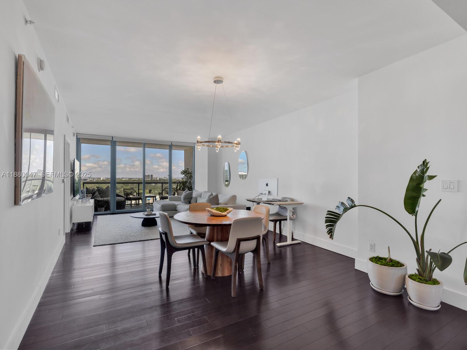 601 Northeast 36th Street, Unit 1304 Miami, FL 33137 - Photo 3 of 40 a view of a dining room with furniture and wooden floor